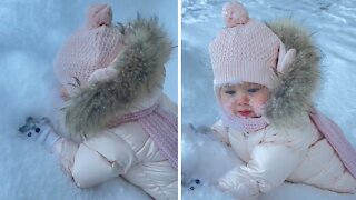 Baby loves snow, puts entire face in it