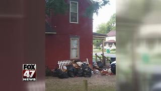 Neighbors concerned about trash piling up outside Mid-Michigan home