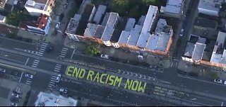 Protesters paint 'end racism now'