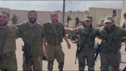 "Save your people" - IDF fighters dance together in a gathering area near the Gaza Strip