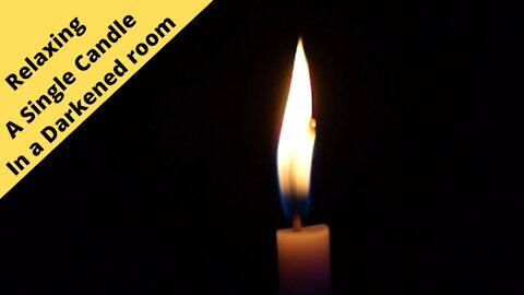 Relaxing A single candle in a darkened room