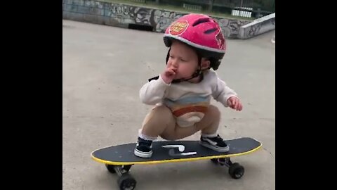 Funny baby skateboarding