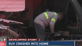 SUV crashes into home