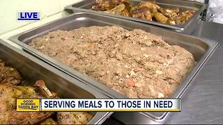 Volunteers from Metropolitan Ministries work to serve meals for those in need