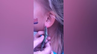 Little Girl Wears A Lizard As An Earring