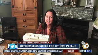 Officer sews shield for others in blue