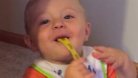 Little Boy Does Magic Trick with Roll of Tape Measurement