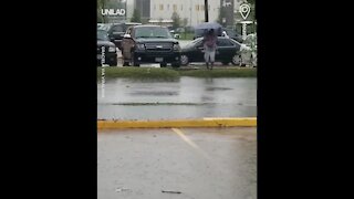 Woman Walks Through Car Park And Falls In Puddle