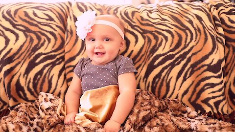 Sweet baby girl plays peekaboo with her dad