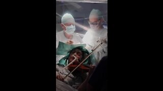 A Musician Plays The Violin During Brain Surgery