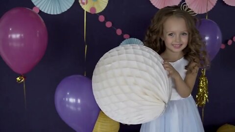 Portrait of little cute girl holding big white balloon concept of birthday party