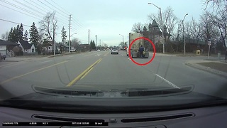 Guy on roller blades hitches ride on back of truck