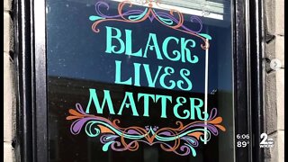 Artist painting 'Black Lives Matter' in windows across Baltimore