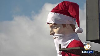 Iconic, 25-foot muffler man gets Christmas swag back