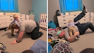 Toddler hilariously shows off impressive wrestling moves on dad