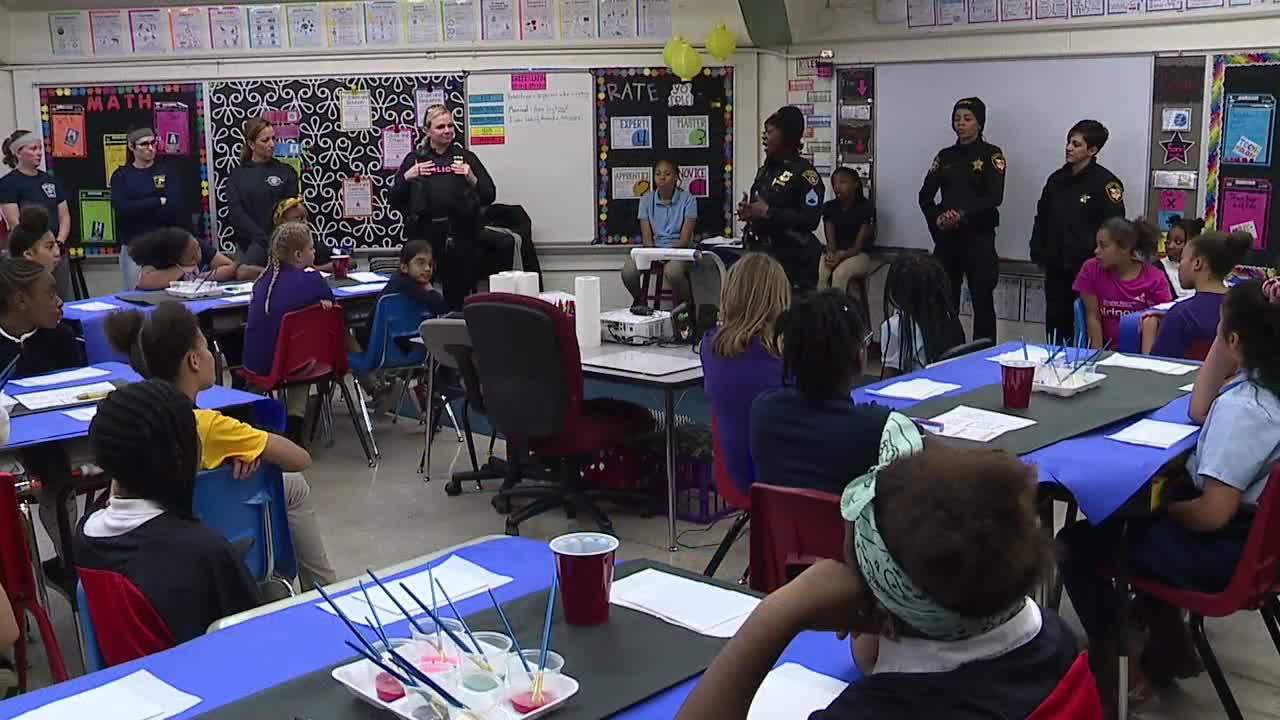 Woman in law enforcement talk to girls at Cleveland school