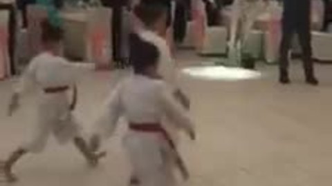 Newlyweds introduced by children's karate display