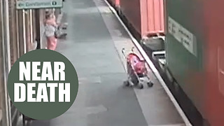 Chilling footage shows moment unattended child's buggy rolls into the path of a freight train