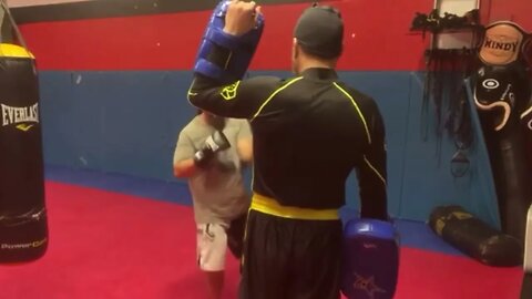 Holding Thai pads for my student and teaching him a new combination at the end