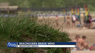 Beachgoers brave windy conditions at Bradford Beach