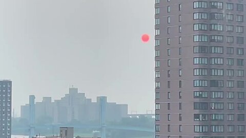 Complete red sun rises over New York City