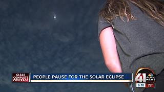 People pause for total solar eclipse