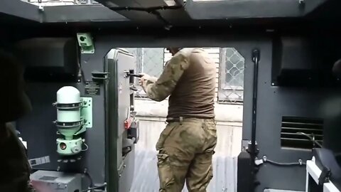 Trophy Varta DPR fighters inspect a captured Ukrainian armored car