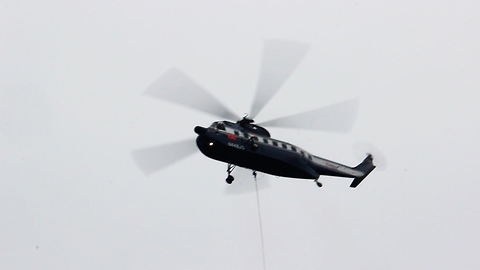Giant helicopter is maxed out to transport massive powerline poles