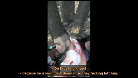 Russian soldiers provide first aid to captive Ukrainian soldiers.