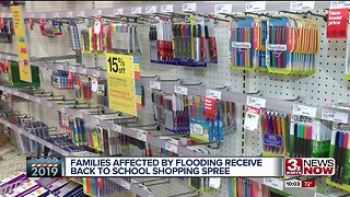 Flooding victims receive back to school shopping spree