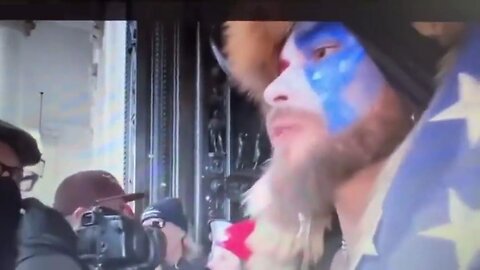 New Video Shows Q-Anon Shaman Reading Trump's Tweet To Stay Peaceful And Go Home To The Crowd