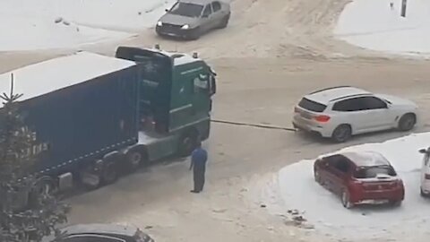 Small car tows a huge truck