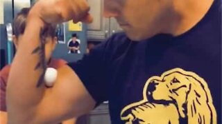 Dad crushes egg with bicep and accidentally hits son with it