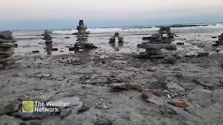 Inukshuks keep watch over rocky shore