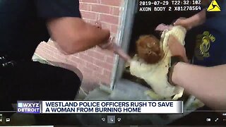 Westland police officers rush to save woman from burning home