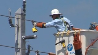 FPL crews installing stronger power poles