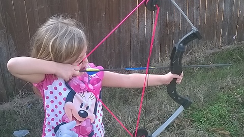 5 Year Old Girl Having Fun With Her Bow