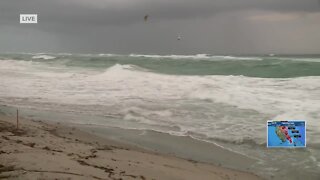 Kitesurfers ride the waves in Juno Beach
