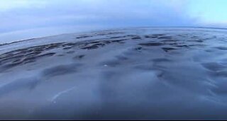 Cold freezes the waves on a lake in Canada