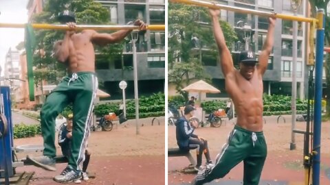 Fitness buff incredibly dances while hanging from pull-up bar