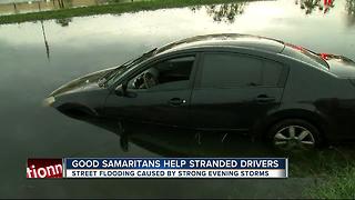 Good Samaritans help stranded drivers from street flooding