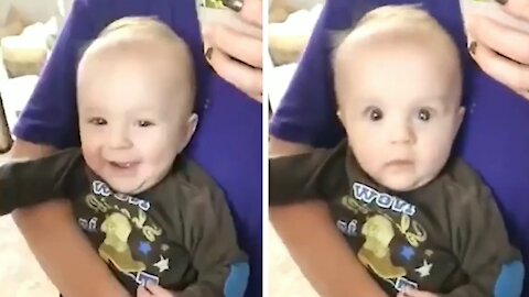 Baby looking in the mirror starts laughing, but soon after he gets scared because of his mommy