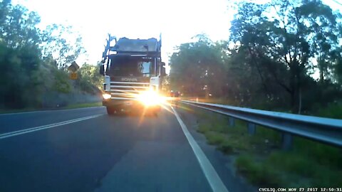 Oncoming truck dangerously squeezes between cyclist and car at high speed