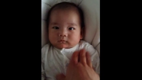 Adorable 6-week-old infant smiles for camera