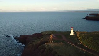 Flying Drone around a Lighthouse at Sunset