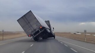 Extreme Alberta winds toy with transport truck before pushing it over
