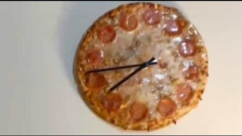 Watch a clock a being made from pizza