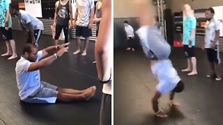 Incredibly athletic man performs multiple impressive flips from a sitting position
