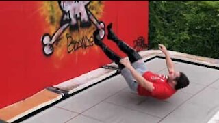 Man jumps on trampoline wearing high heels