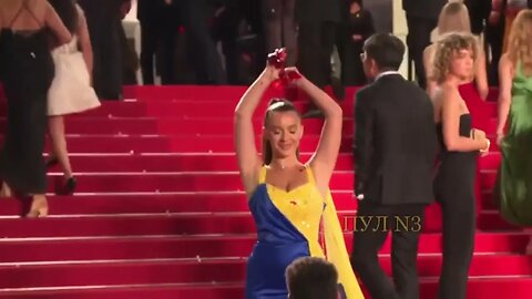 Woman dressed in Ukrainian colours stages protest on Cannes red carpet, pours fake blood on herself